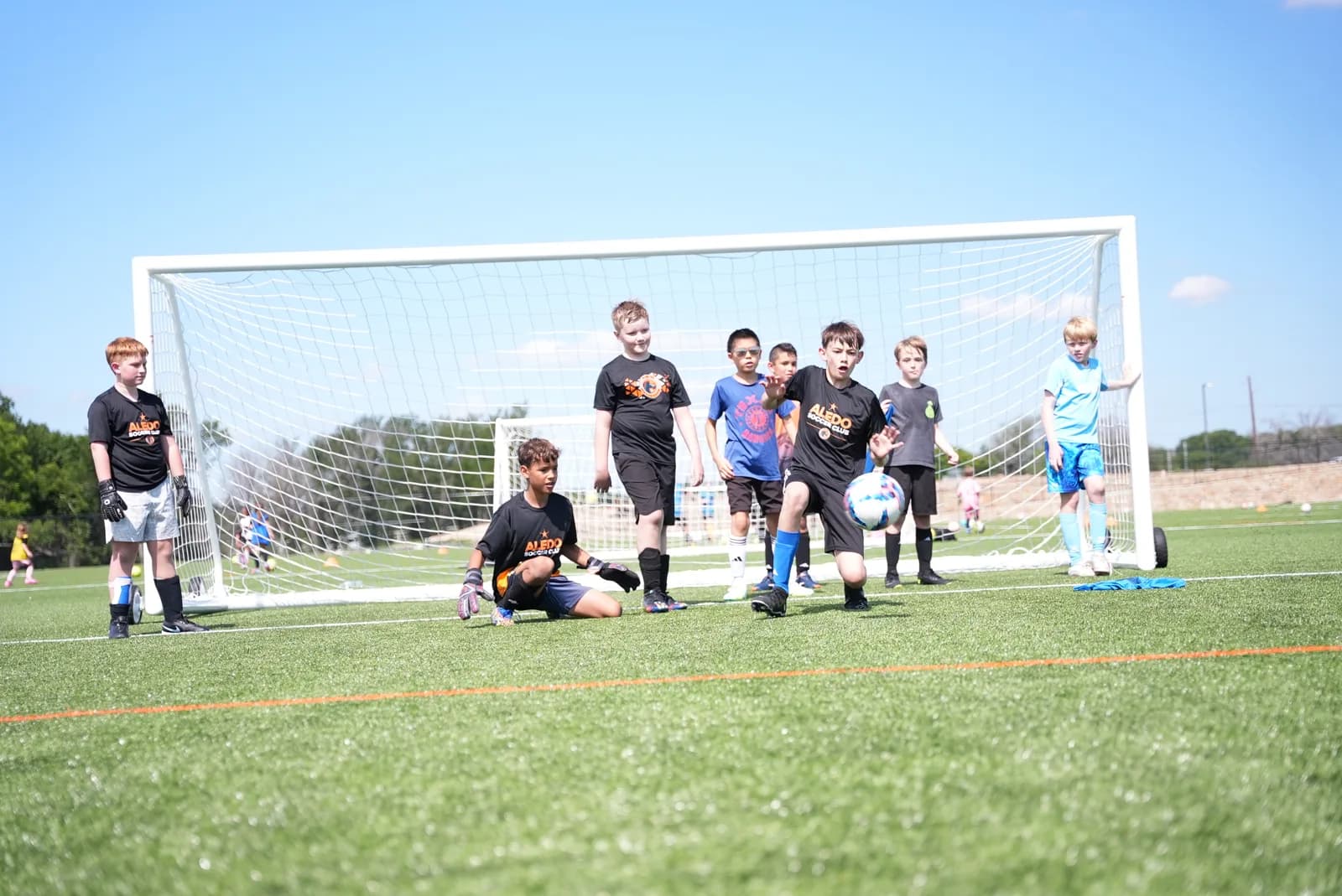 A group of young Little Aledos players defending the goal together during small-sided play at The Stable