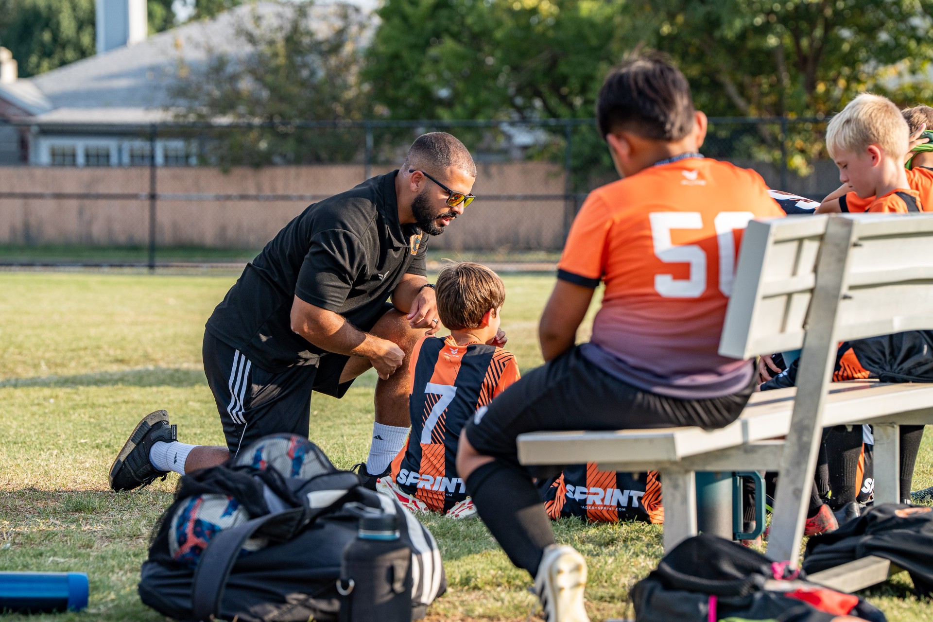Coach speaking with players on the bench
